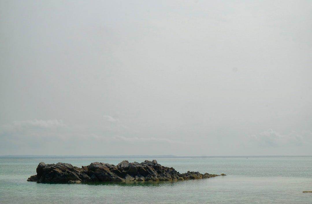 Local fishermen casting nets in the shallow waters off Motobu, Okinawa's scenic northern coast