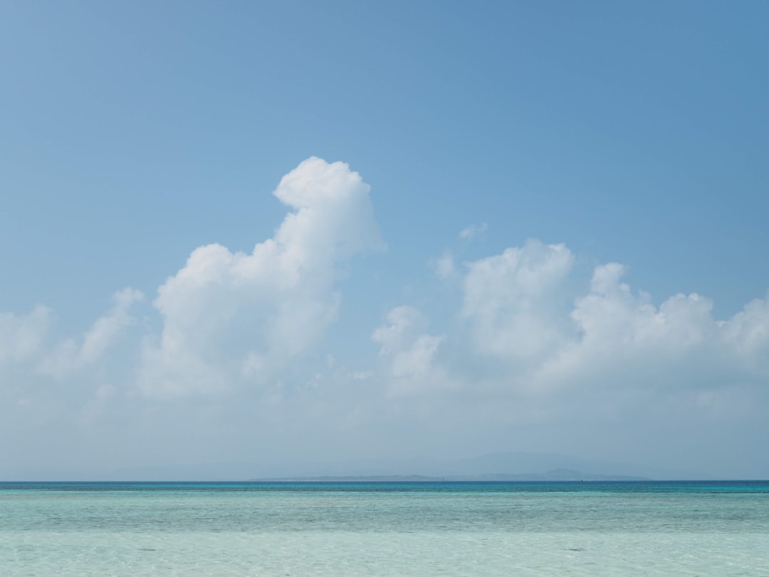 Crystal-clear East China Sea near Chatan coastline the morning after a typhoon passed, September 2023, with no visible storm damage on the beach