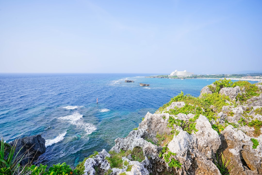 Limestone cliffs and the reef edge at Cape Manzamo in Onna Village on Okinawa main island in mid-afternoon sun