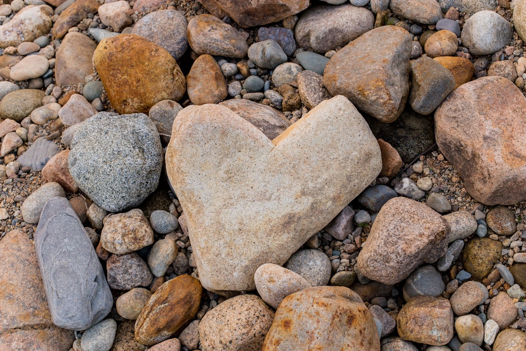 Heart Rock at Tinu Beach on the north shore of Kouri Island, two rock stacks standing above the exposed reef flat at low tide